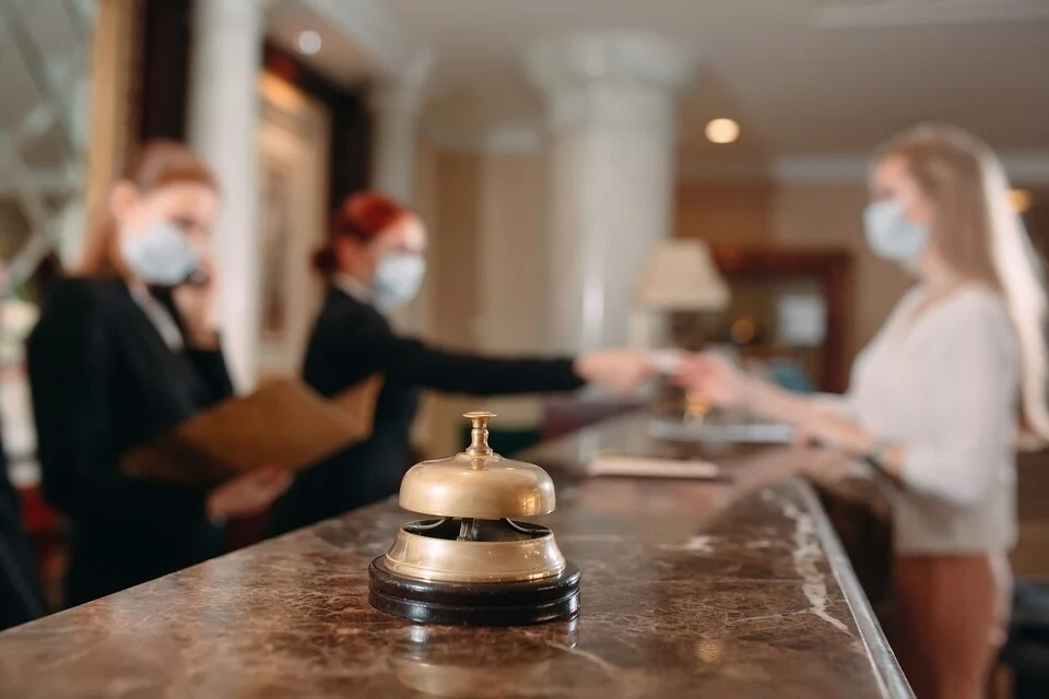 Hotel front desk with staff assisting a guest, representing concierge security services in Chicago, IL