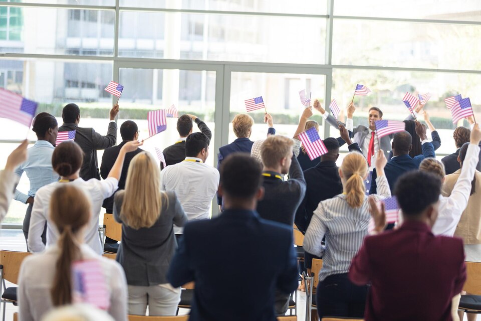 Attendees waving flags at a political gathering inside a venue in Chicago with event security support