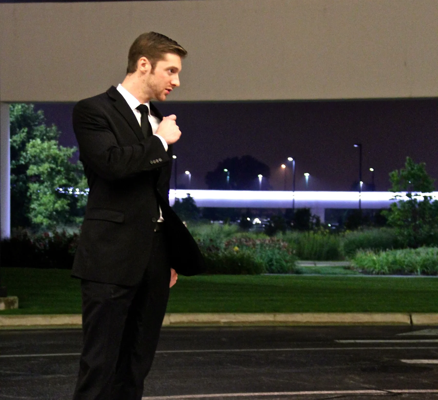 Plainclothes executive protection specialist communicating by radio in Chicago at night - 60656