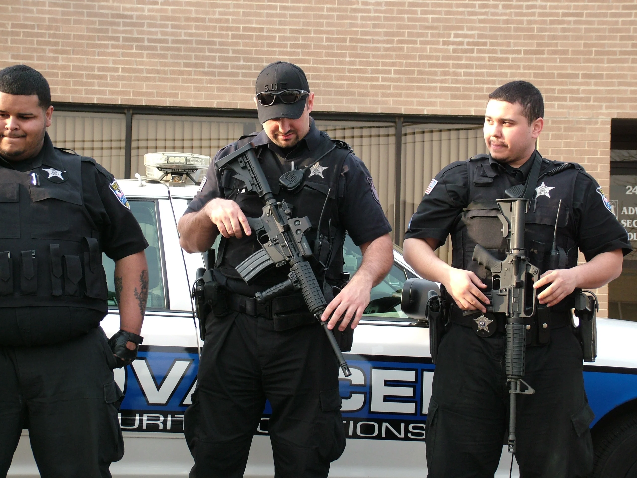 Armed security team in tactical gear preparing for an executive protection assignment - 60656