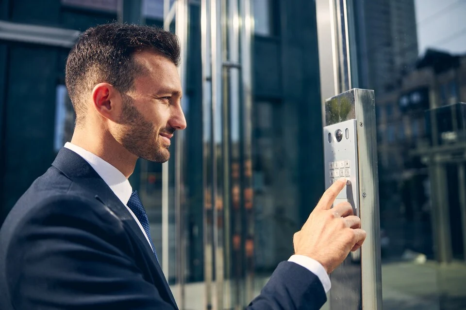 Professional unlocking a secured building entrance using a keypad as part of response & lockup services in Chicago, IL.