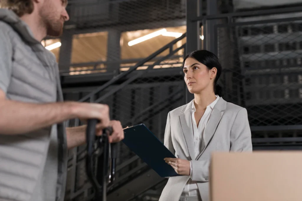Security manager holding a clipboard in a warehouse to evaluate contract security vs in-house security in Chicago.